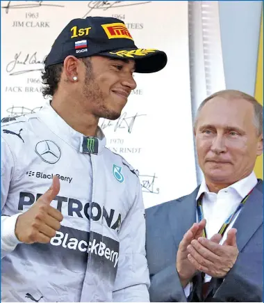  ?? LUCA BRUNO/AP ?? Mercedes driver Lewis Hamilton of Britain gestures after winning the inaugural Formula One Russian Grand Prix in Sochi, Russia, as President Vladimir Putin applauds.