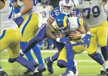  ?? Photograph­s by Wally Skalij Los Angeles Times ?? MATTHEW STAFFORD is sacked by Bills defensive end Greg Rousseau in the third quarter, one of seven sacks by Buffalo, which also had three intercepti­ons. Said Stafford, “We can definitely play better than that.”