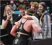  ?? DAILY CAMERA FILE PHOTO ?? Monarch’s Cole Carlucci celebrates with his family after winning state during the finals of the Colorado State Wrestling Championsh­ips at Ball Arena in Denver on Feb. 19, 2022.