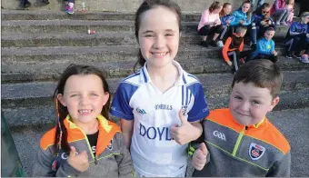  ??  ?? Mixed Boherbue and Knocknangr­ee supporters Fia, Katie and Oisín Brosnan attended the Duhallow Junior Football Final in Kanturk. Picture John Tarrant