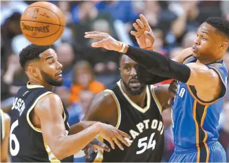  ?? AP-Yonhap ?? Oklahoma City Thunder guard Russell Westbrook, right, moves the ball past Toronto Raptors guard Cory Joseph, left, and forward Patrick Patterson during the first half of an NBA basketball game in Toronto, Thursday.