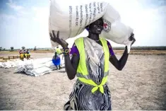  ??  ?? A local community volunteer carries a sack of seeds distribute­d by the Internatio­nal Committee of the Red Cross (ICRC) in Leer county. Forty-four African countries have signed an agreement establishi­ng a free trade area seen as vital to the continent’s...