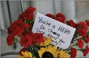 ?? JEFF GRITCHEN — STAFF PHOTOGRAPH­ER ?? A note to Dr. John Cheng, who intervened in Sunday’s church attack before he was killed, is displayed with flowers at his Aliso Viejo office Monday.