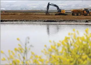  ?? ?? Constructi­on equipment for the South San Francisco Bay Shoreline Project is photograph­ed along Pond A12at Alviso Marina County Park on April 14 in San Jose. Phase 1of the flood control project is scheduled to be completed in January 2024.