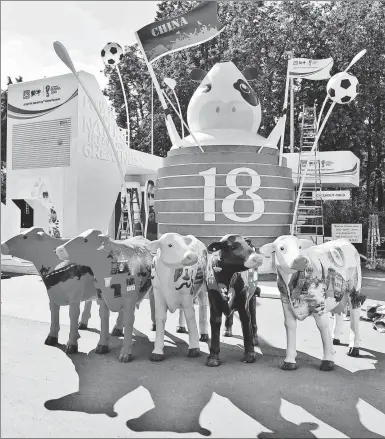  ?? PHOTOS BY LIU ZHANKUN / CHINA YOUTH DAILY ?? The booth of Mengniu, a dairy producer based in North China’s Inner Mongolia autonomous region, stands outside a World Cup venue in Moscow. Mengniu is one of seven Chinese companies sponsoring the tournament.