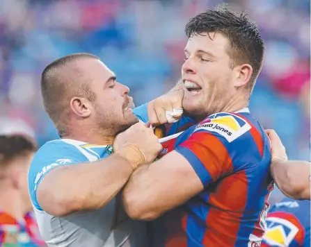  ?? Picture: AAP IMAGE ?? Titans forward Keegan Hipgrave (left) gets up close and personal with Newcastle’s Lachlan Fitzgibbon.