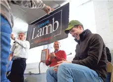  ?? ANTONELLA CRESCIMBEN­I/AP ?? Democratic contender Conor Lamb, sporting a hat given to him at a rally Sunday with union workers, is running strong in a district that voted solidly Trump.