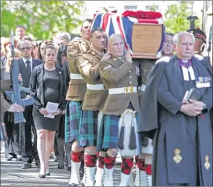  ??  ?? SERVICE: Cpl William Savage’s wife Lyndsey follows the coffin at Glencorse Kirk in Penicuik. Picture: Stewart Attwood