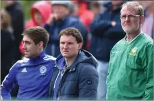  ??  ?? Kenmare District players Adrian Spillane, far left, and Tadhg Morley, are interested spectators at the Kenmare Shamrocks versus Legion county SFC match in Direen on Sunday.