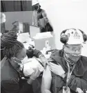  ?? STEPHEN M. KATZ/STAFF ?? Rodney Taylor, a structural welder, receives a vaccine from LPN Nakia McClary during Newport News Shipbuildi­ng’s coronaviru­s clinic March 19.