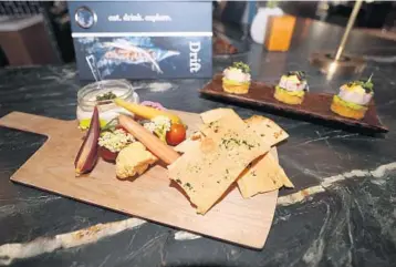  ?? JOHN MCCALL/SUN SENTINEL ?? Labneh with vegetables and flat bread and lobster and avocado toast are served at Drift Kitchen and Bar in Delray Beach.