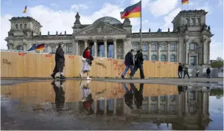  ?? ?? Passers-by walk past the Reichstag building in Berlin Friday, April 5, 2024.