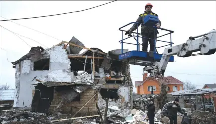  ?? The Associated Press ?? Workers check a destroyed residentia­l area after a Russian rocket attack in Hlevakha, Kyiv region, Ukraine, Thursday.