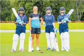  ?? Photo / Joe Allison, Allison Images ?? White Ferns all-rounder Suzie Bates (second from left) with young cricketers.