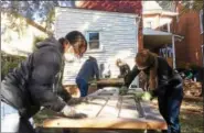  ?? EVAN BRANDT — DIGITAL FIRST MEDIA FILE PHOTO ?? Volunteers from Habitat for Humanity of Montgomery County’s Women Build program strip coatings from the original doors at 430 Walnut St. in Pottstown.