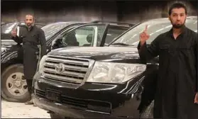  ??  ?? Caring: Talha Asmal, right, in front of a Toyota in the terrorists’ video