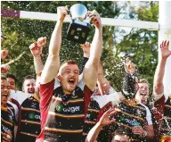  ?? ?? It’s ours: Josiah Dicknson lifts the trophy for Caldy