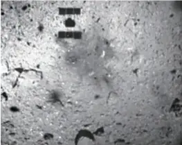  ?? Courtesy of JAXA, others ?? This image captured by Hayabusa2 during its ascent after touching down on Ryugu shows the surface of the asteroid, including a shadow of the spacecraft’s body.