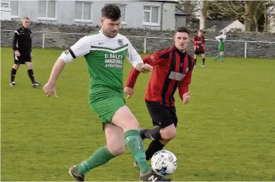  ?? Pic: PAUL SCHOLES ?? Bro Goronwy’s Graham Jones challenges Bodedern’s Casey Boylan (green and white)