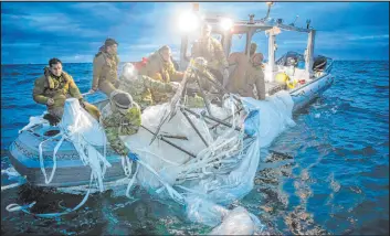  ?? U.S. Navy ?? U.S. Navy sailors retrieve remains of a surveillan­ce balloon on Feb. 5 off the coast of Myrtle Beach, S.C. Recovery of pieces of the possible spy balloon ended Thursday.