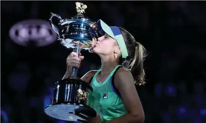  ?? Photograph: Saeed Khan/AFP via Getty Images ?? Sofia Kenin of the United States kisses the Daphne Akhurst Memorial Cup after defeating Spain’sGarbiñe Muguruza to win the Australian Open in February.