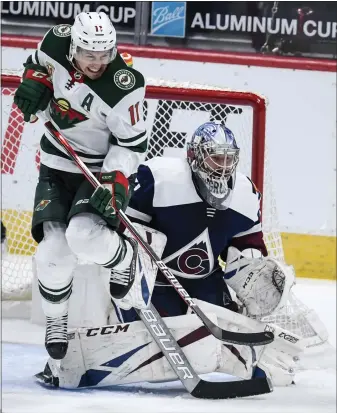  ?? DENVER POST FILE PHOTO ?? Zach Parise (11) of the Minnesota Wild and Philipp Grubauer (31) of the Colorado Avalanche brace for a shot during the second period on Tuesday, Feb. 2, 2021.