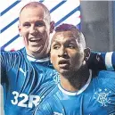  ??  ?? Kenny Miller celebrates with scorer Alfredo Morelos.