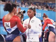  ?? Laurence Griffiths / TNS ?? Simone Biles talks with Jordan Chiles of Team United States during the Women’s Team Final at the Tokyo 2020 Olympic Games at Ariake Gymnastics Centre on Tuesday in Tokyo.