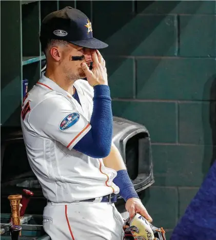  ?? Karen Warren / Staff photograph­er ?? Alex Bregman takes a moment in the dugout after Game 5 to process the fact that the Astros have reached the end of the line.