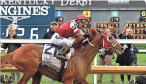  ?? TIMOTHY D. EASLEY/SPECIAL TO THE COURIER-JOURNAL ?? Rich Strike, with Sonny Leon up, crosses the finish line to win the 148th running of the Kentucky Derby on May 7.