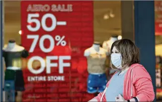  ?? TONY DEJAK / ASSOCIATED PRESS ?? Friday’s Commerce Department report showed June’s increase in consumer spending coincided with a 1.1% drop in personal incomes, which followed an even bigger 4.4% fall in incomes in May.