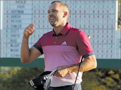  ?? AP/CHARLIE RIEDEL ?? Sergio Garcia expresses delight after making a 7-foot par-saving putt at No. 18 to keep him atop the leaderboar­d after three rounds of the Masters on Saturday in Augusta, Ga. Garcia shot a 70 in the third round and is tied with Justin Rose, who shot a...