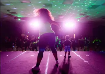  ??  ?? Maria Sanchez, of el Centro, and her 2-year-old son lead the crowd while on stage during the back to School Supplies Zumbathon on Friday at imagine Schools at imperial Valley in el Centro. PHOTO VINCENT OSUNA