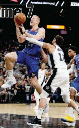  ??  ?? Mason Plumlee of the Denver Nuggets (left) gets fouled by Marco Balinelli of the San Antonio Spurs in Game Six of their first round Western Conference playoff series at the AT&T Center in San Antonio. The Spurs won, 120-103. (AFP)