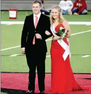  ??  ?? Farmington junior maid Kate Allyn Cox, daughter of Lance Cox and Brandi Cox, escorted by her brother, Hayes Cox.