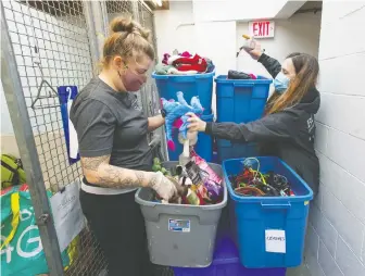  ?? JASON PAYNE ?? Diane Waters, left, the co-ordinator of Charlie's Community Pet Resources, sorts through donated items at the BCSPCA on Thursday with Kim Monteith, manager of animal behaviour and welfare.