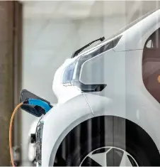  ?? — Bloomberg photo by Angel Garcia ?? An XEV Yoyo electric vehicle charges at an Autosi car dealership in Granollers, Spain.