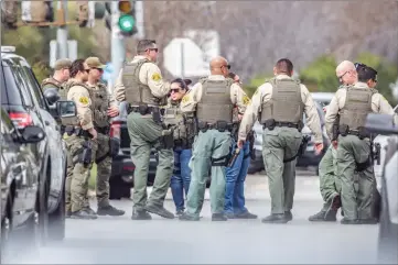  ?? Cory Rubin/The Signal ?? Los Angeles County sheriff’s deputies debrief following a search for a man with a firearm on Seco Canyon Road and Decoro Drive in Saugus on Tuesday afternoon. Several schools were on lockdown during the search.