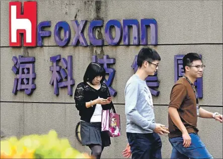  ?? Sam Yeh AFP/Getty Images ?? THE TAIWAINESE electronic­s giant Foxconn says it fired two executives amid allegation­s of misusing interns at a factory in China.