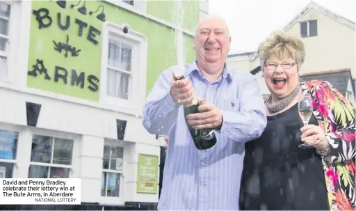  ?? NATIONAL LOTTERY ?? David and Penny Bradley celebrate their lottery win at The Bute Arms, in Aberdare