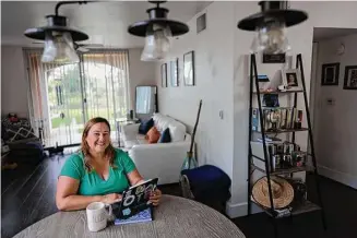  ?? Rebecca Blackwell/Associated Press ?? Melissa Lombana, 43, a high school teacher and mountain bike enthusiast, in her one-bedroom apartment in Miramar, Fla., last week.