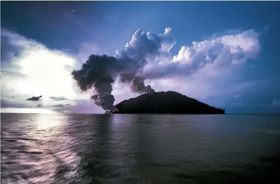  ?? PHOTO: AP ?? In this photo taken on Tuesday, January 16, ash plumes rise from the volcano on Kadovar Island, Papua New Guinea.