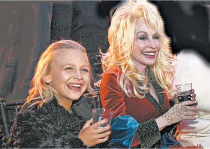  ?? ANNETTE BROWN/NBC ?? Alyvia Alyn Lind, left, and Dolly Parton appear in “Dolly Parton’s Christmas of Many Colors: Circle of Love.”