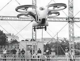  ?? KOJI SASAHARA/AP ?? NEC Corp.’s “flying car” with four propellers hovers at the company’s facility in Abiko near Tokyo, on Monday.