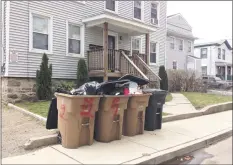  ?? Angela Carella / Hearst Connecticu­t Media ?? Overflowin­g garbage cans on the curb along Henry Street in Stamford.