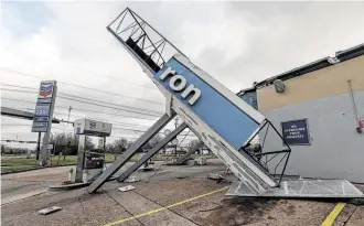  ?? Steve Gonzales / Staff photograph­er ?? Strong winds toppled the canopy at a Chevron gas station in southwest Houston.