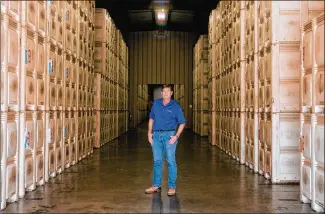  ?? PHOTOS BY ROZETTE RAGO / THE NEW YORK TIMES ?? Scott Phippen, stands amid some 30 million pounds of almonds in Manteca, California, waiting for means to ship them to customers overseas. Many shippers are sending empty containers back to China rather than reloading them with California’s agricultur­al bounty.