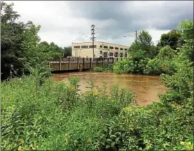  ?? EVAN BRANDT — DIGITAL FIRST MEDIA ?? High water on Manatawny Creek was just low enough to slide under the King Street bridge in Pottstown Monday, Aug. 13.