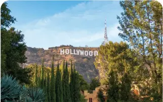  ?? ?? FAMOUS HOLLYWOOD SIGN, Los Angeles, below; fun at the beach in Santa Monica, opposite.