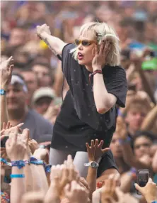  ?? Scott Eisen / Associated Press 2013 ?? Alice Glass of Crystal Castles joins fans offstage while performing at the 2013 Lollapaloo­za Festival in Chicago.